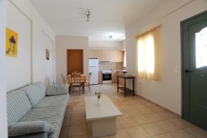 a living room with a couch and a table at Veranta Me Thea in Agios Ioannis +28 photos