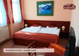Postel nebo postele na pokoji v ubytování Hotel Podhradie