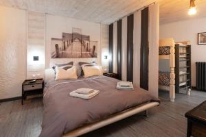 a bedroom with a large bed with towels on it at DMB - Domaine avec SPA in Meslan