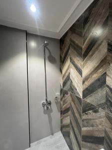 a bathroom with a shower with a glass door at Top Notch- 2 BHK Condo Travel Pin in Lahore