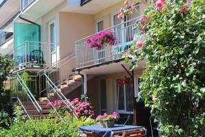 a building with balconies and flowers in a yard at Willa Pasat in Władysławowo