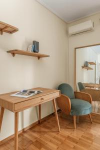 a wooden table and chairs in a room at Casa Riviera-Newly Renov 2Br Luxury Apt near Sea in Athens