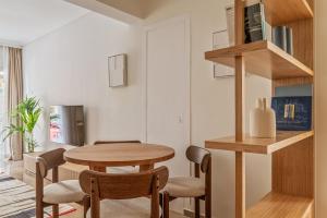 a dining room with a wooden table and chairs at Casa Riviera-Newly Renov 2Br Luxury Apt near Sea in Athens +20 photos