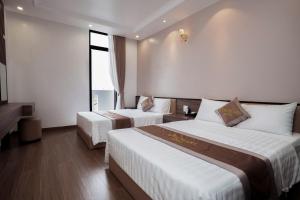 Postel nebo postele na pokoji v ubytování De Pearl Hotel + 21 fotografií