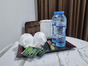 a bottle of water sitting on a tray on a table at shafranhotel in Tashkent