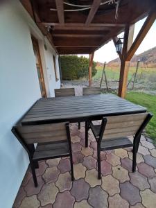 a wooden table and benches on a patio at Vreni's Gästezimmer in Himmelried