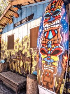 a building with a painting of a face on it at Guarda Garden Cabanas in Palhoça