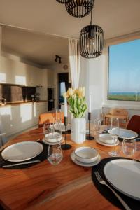a dining room table with plates and candles on it at Meerblick 8 - zwischen Haven und Meer in Wilhelmshaven