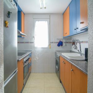 a small kitchen with a sink and a dishwasher at Natura Mediterranea Torremar atico 1 dorm naturista 430 in Playas de Vera