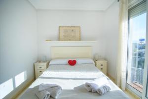 a bedroom with a bed with a red heart on it at Natura Mediterranea Torremar atico 1 dorm naturista 430 in Playas de Vera