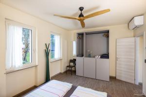 a bedroom with a bed and a ceiling fan at Residence Alesi in Malcesine