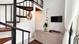 a living room with a staircase and a couch at Villa kumudini's 2 in Diyeng