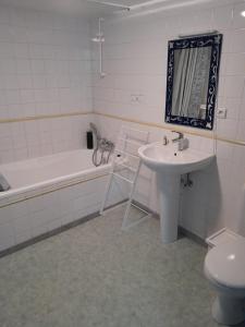a bathroom with a sink and a tub and a toilet at Chez Marie-Angèle in Treignes +13 photos