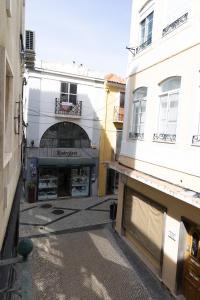 an empty street in a city with buildings at Chic Duplex in the heart of Setúbal in Setúbal