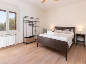 a bedroom with a large bed and a window at Mas Mare de la Font: La Forja / 1094 in Castelló d'Empúries +35 photos