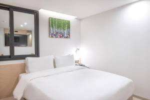 Postel nebo postele na pokoji v ubytování Hotel BELLUS