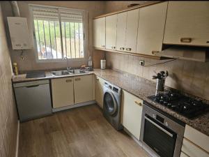 a kitchen with a washing machine and a sink at La Cañada in Partida de La Cañada +5 photos