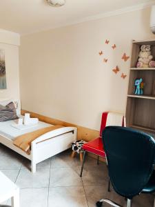 een slaapkamer met een bed en een stoel bij Καινούριο Ανεξάρτητο Διαμέρισμα in Nafplio