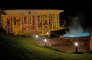 a house with a swimming pool at night at Ronnums Herrgård in Vargön
