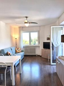 a living room with a blue couch and a table at Casa Marco in Nago-Torbole