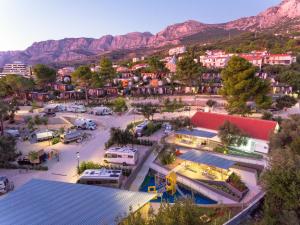 an aerial view of a town with mountains in the background at Medora Orbis Camping Pitches in Podgora