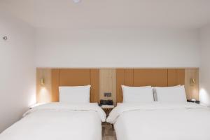 Postel nebo postele na pokoji v ubytování Hotel BELLUS