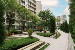 a park in a city with trees and a building at Lacasita Near Beach Huahin (Room652) in Hua Hin