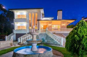 a large house with a fountain in front of it at Majestic Manor in Valença with private pool in Valença