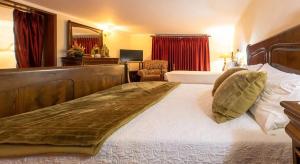 a bedroom with a large bed with a wooden headboard at Majestic Manor in Valença with private pool in Valença +45 photos