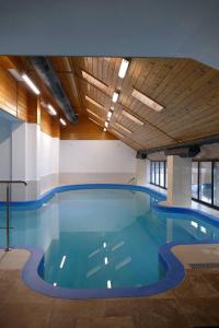 a large swimming pool in a large building at Pensiunea Varvara de Bucovina in Gura Humorului