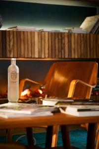 a bottle of alcohol sitting on top of a wooden table at COQ Hotel Paris in Paris
