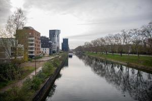 a river in the middle of a city with buildings at Appartement moderne au centre ville in Strasbourg +74 photos