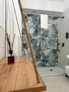 a bathroom with a wooden table in front of a wall at Tropical House in Gizzeria +95 photos