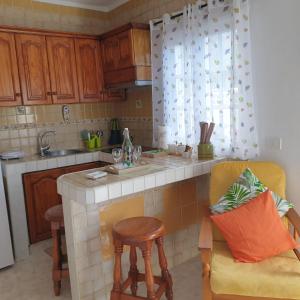 a kitchen with a counter and a chair and a sink at Roque Blanco in Frontera +16 photos