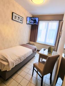 TV a/nebo společenská místnost v ubytování Hotel De Golf
