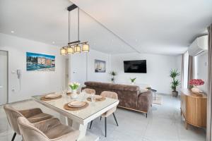 a living room with a table and a couch at 3rd Floor Apartman in Kaštela