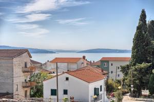 a city with buildings and a lake in the background at 3rd Floor Apartman in Kaštela