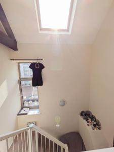 a small attic room with a tshirt hanging on the ceiling at Room bhm city centre in Birmingham +1 photo