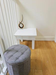 a white table and a stool in a room at Room bhm city centre in Birmingham