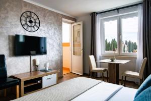 a hotel room with a bed and a desk and a tv at Luma Studio in Dubrovnik