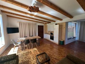 a kitchen and living room with a table and chairs at Svetli Raj in Pregrada