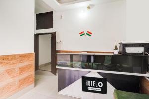a room with a hotel sign on the wall at Super Hotel O Pradhan Nagar Siliguri Formerly Prince Guest House in Siliguri