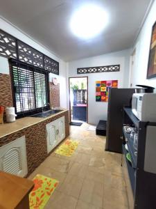 a kitchen with a counter and a counter top at Relax Bungalow Bang Por, Koh Samui in Ban Tai