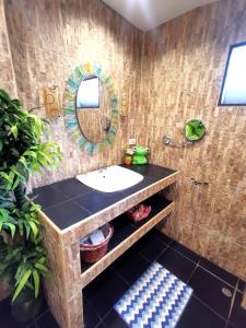 a bathroom with a sink and a mirror at Relax Bungalow Bang Por, Koh Samui in Ban Tai