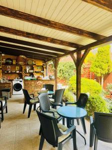 a patio with tables and chairs and a kitchen at Sailor's Apartman in Siófok +22 photos