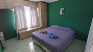 a bedroom with a bed with two stuffed animals on it at Departamento Costa Del Sol - 2 dormitorios in Neuquén