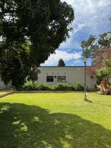 a building in a yard with a green lawn at Sable Suites C1, 1 Bed Apartments in Kabulonga in Lusaka