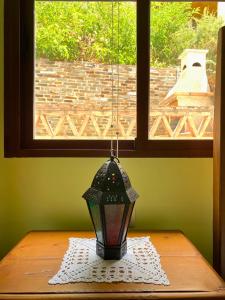 a lamp sitting on a table in front of a window at La Golondrina in Cáñar +25 photos