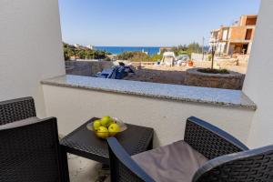 a bowl of fruit on a table on a balcony at Aurora Apartments in Bar