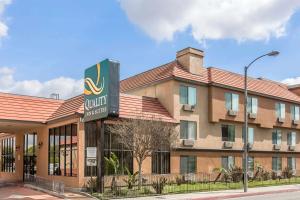 a hotel with a sign in front of a building at Quality Inn & Suites Bell Gardens-Los Angeles in Bell Gardens